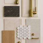 Flat lay of apartment renovation finishes including tile, faucet, cabinet sample, wood flooring, and hardware.